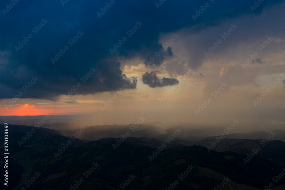 Drone view of epic sunset with rainy clouds in Transylvania, Romania. Drone view of epic sunset with rainy clouds in Transylvania, Romania.