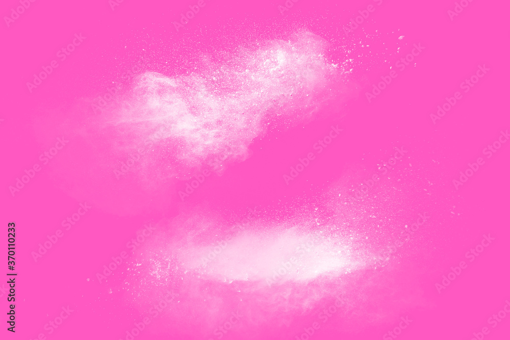 Obraz premium Freeze motion of white particles on pink background. Abstract white dust explosion.