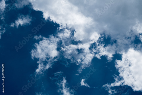 floating white cloud in bright blue sky in sunny day