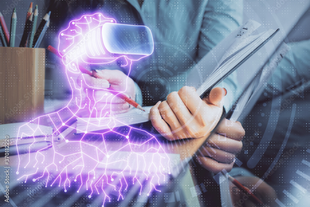 Fototapeta premium AR hologram over hands taking notes background. Concept of augmented reality. Double exposure