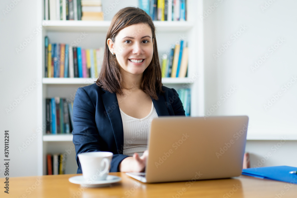 Laughing caucasian businesswoman at computer Laughing caucasian businesswoman at computer
