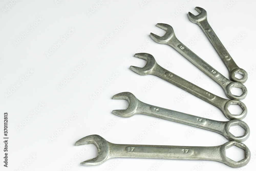 Five different wrenches lie on the right on a white background Five different wrenches lie on the right on a white background