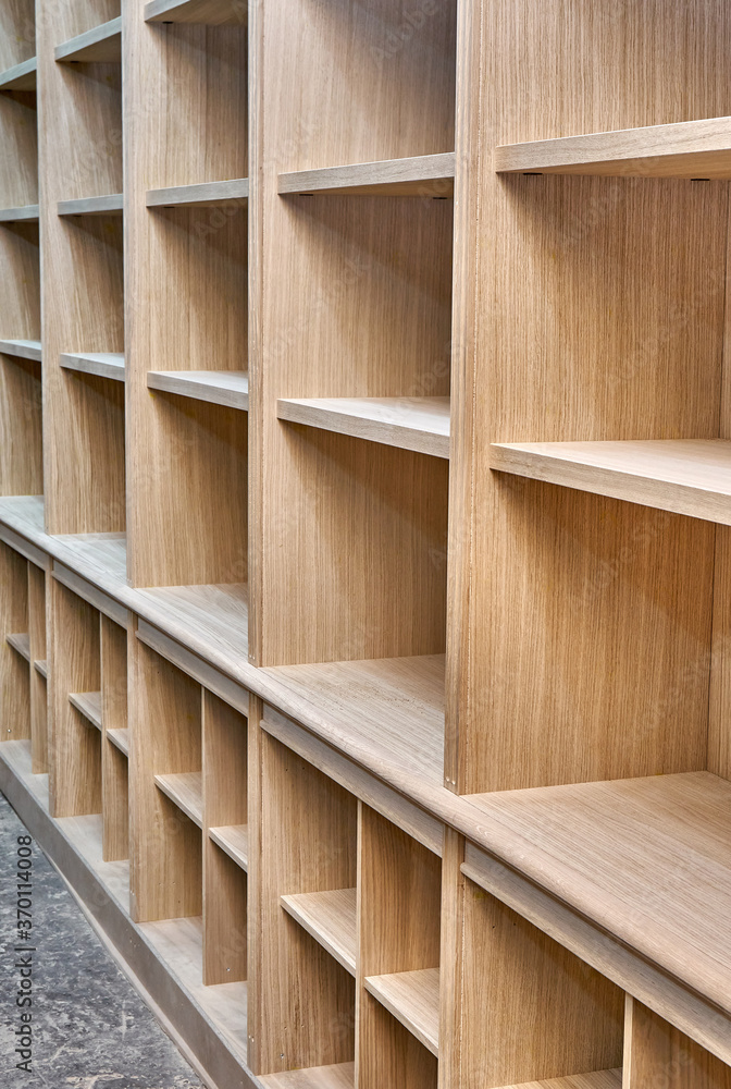 Modern joinery. Wooden bookcases in process of production in workshop. Furniture manufacture Modern joinery. Wooden bookcases in process of production in workshop. Furniture manufacture