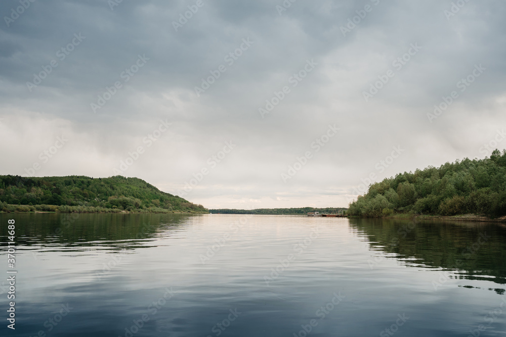 calm river on an overcast day in summer