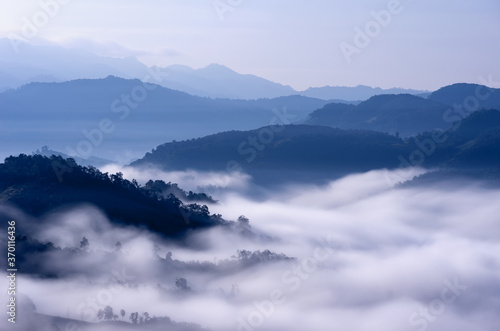 Beautiful fog with warm light over mountain.