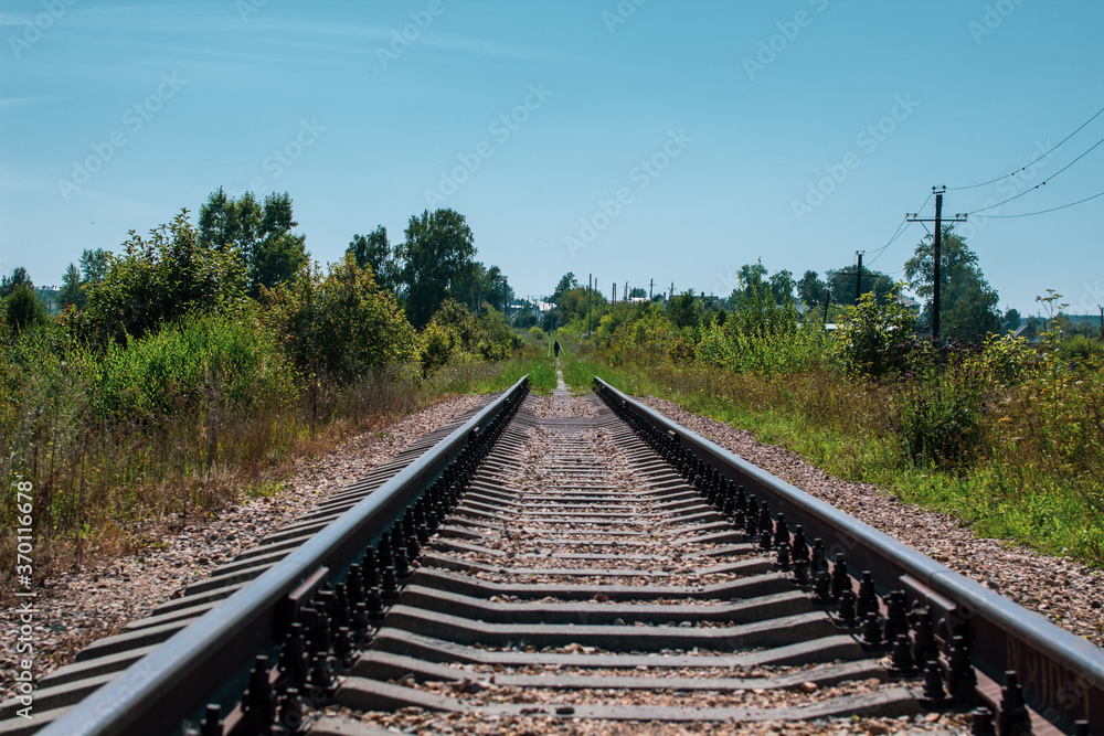 Railway tracks and gravel leading into the infinite distance