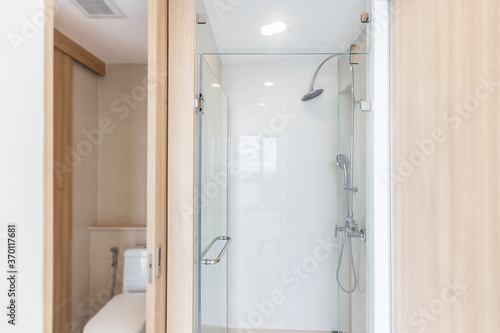 Stainless steel shower in small bathroom at apartment