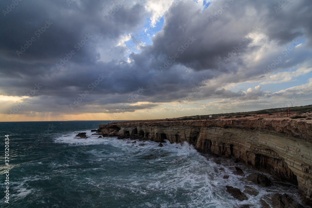 Stormy Weather sunset at sea Caves in Cape Grego Ayia Napa, Cyprus 