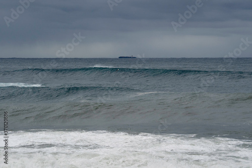 Bib waves rolling into the beach, massive surf day