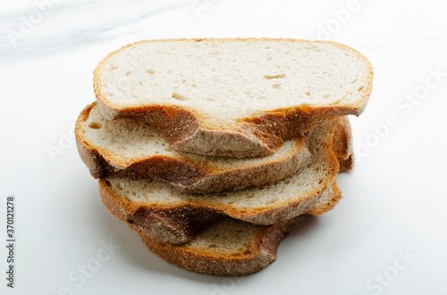 Принти на полотні Closeup of stack slices of rye brad on the white background
