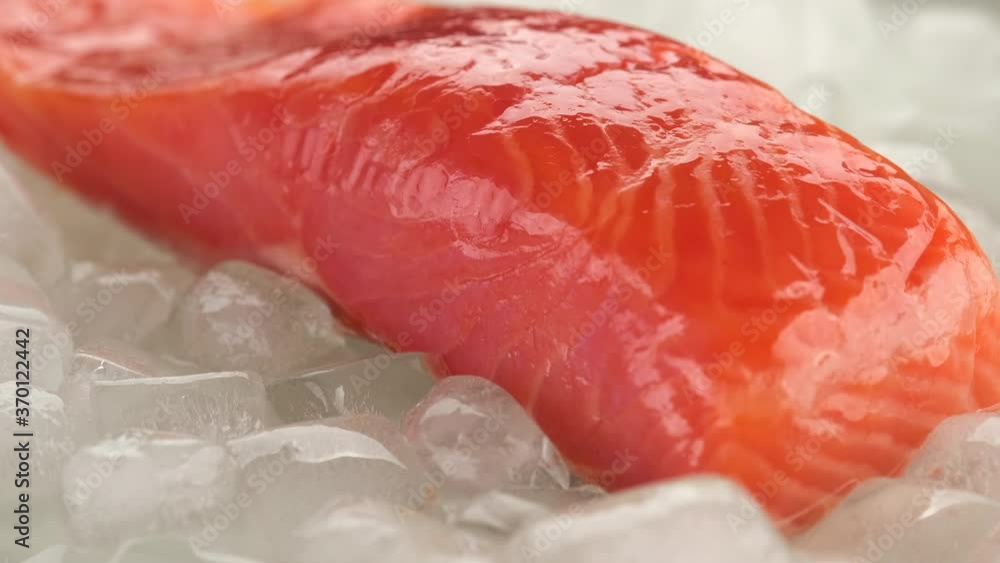 fresh salmon steak on ice cubes rotating fresh salmon steak on ice cubes rotating