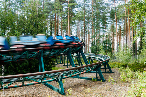 Ride Roller coaster in motion in amusement park at summer day