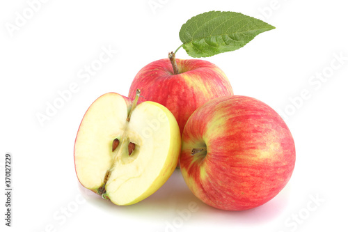 Two red apples and half with leaf isolated on white