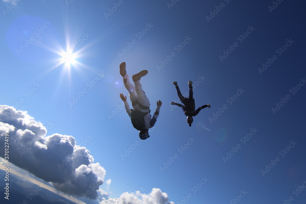 Skydivers over snowy mountains in Norway