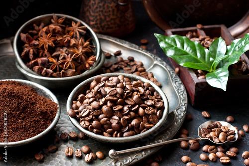 Coffee beans and ground powder on dark background