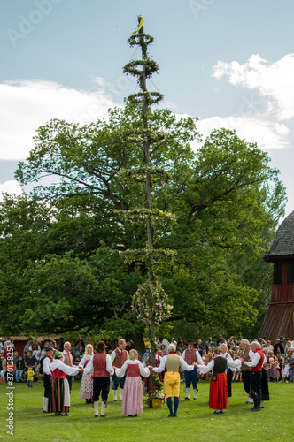 Raising of a midsummer pole duringa a traditional celebration of swedish midsummer in the small town of Skara photo