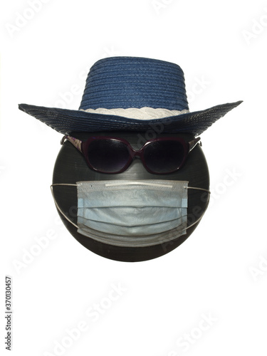 Mannequin head with sunglasses in a hat and in a protective mask isolated on a white background.