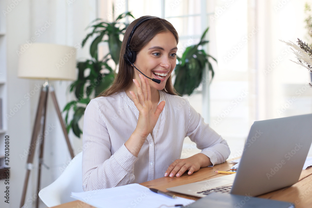 Female customer support operator with headset and smiling. - obrazy, fototapety, plakaty 