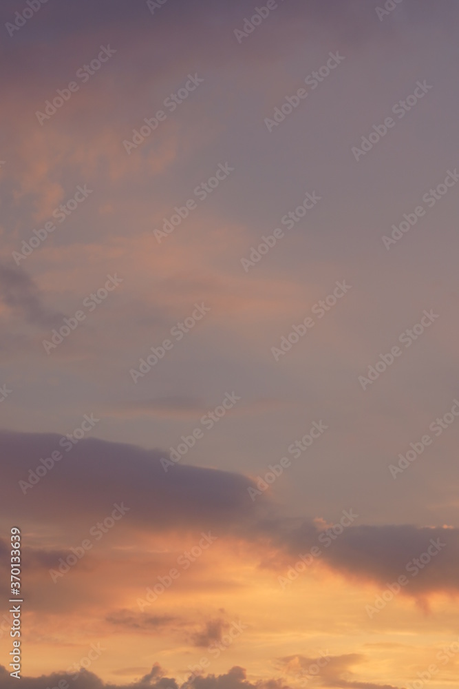 Beautiful evening blue sky at sunset with flaming bright light clouds. A warm summer evening at sunset. Beautiful evening blue sky at sunset with flaming bright light clouds. A warm summer evening at sunset.