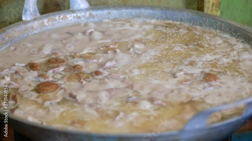 Jengkol stew (jengkol tahi lala)  is traditional Indonesian food, made from jengkol seed (archidendron pauciflorum) cooked in a spicy chili sauce, coconut milk and herb, served on pan. photo