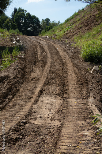 Dirt road with tracks of tracked vehicles