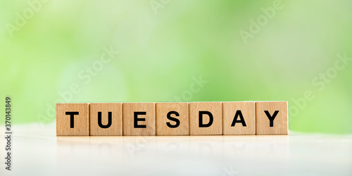 Tuesday text in a wooden cube for banner or background web photo