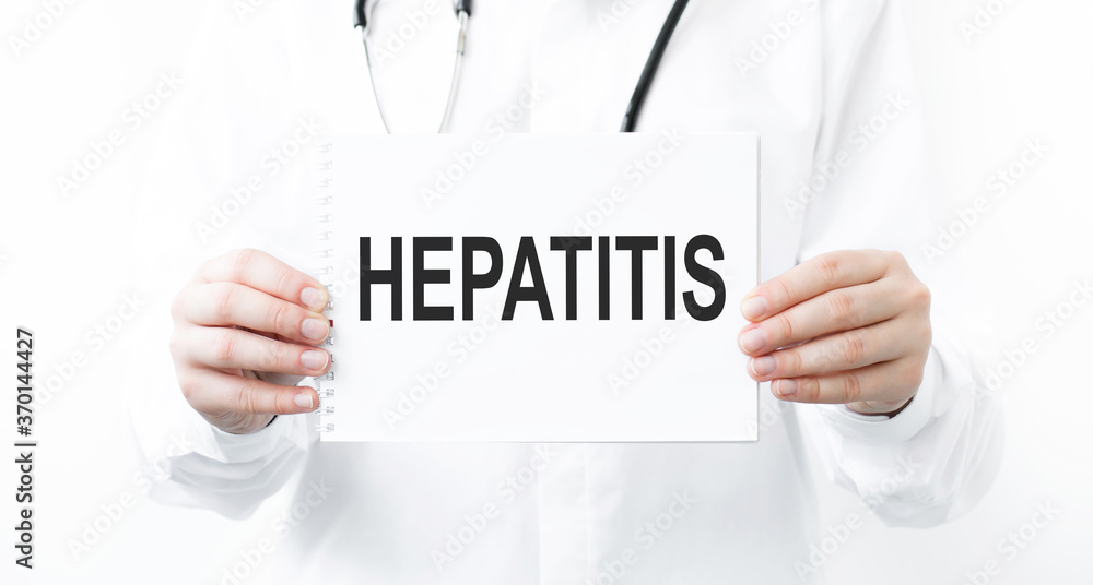 Hepatitis word on the sheet in the hands of the doctor. Treatment concept Hepatitis word on the sheet in the hands of the doctor. Treatment concept