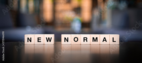 new normal,word on wooden cubes, affectation after covid-19 pandemic..