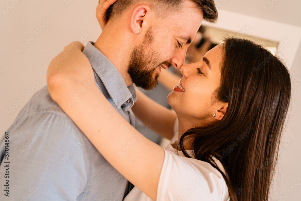 Fototapeta premium Portrait lovely couple hugging each other, smiling, enjoying time together