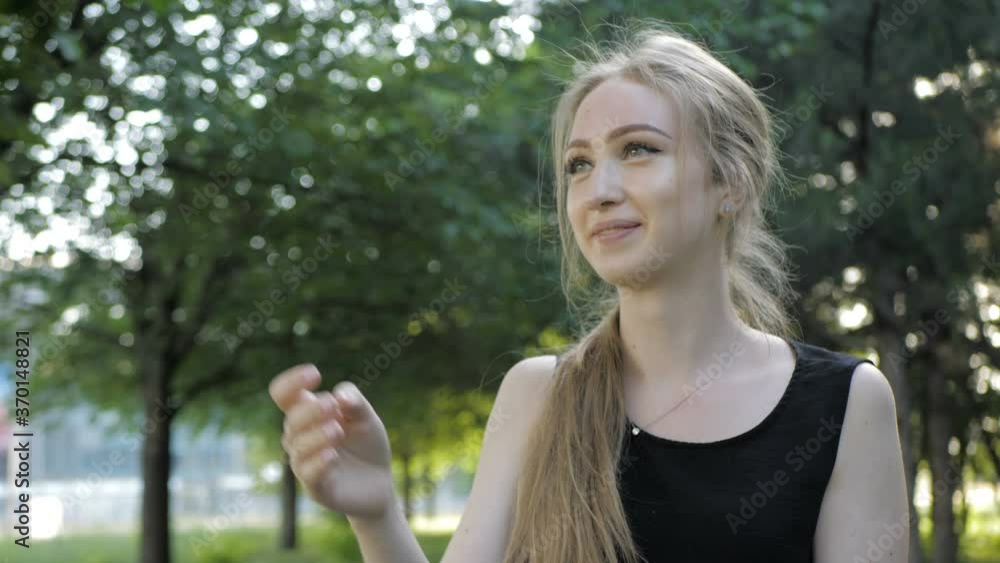 Beautiful blonde girl is sitting in wheelchair and having fun by playing and throwing plate Beautiful blonde girl is sitting in wheelchair and having fun by playing and throwing plate