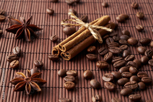 Wallpaper Mural Roasted whole coffee beans, tied sticks of cinnamon and anise on a dark background Torontodigital.ca