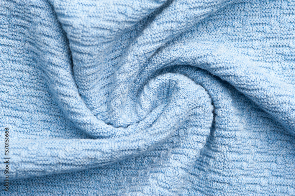 Close-up fragment of warm knitted blue sweatshirts. Concept of warm everyday things. clothing store concept. Advertising space. Place for text Close-up fragment of warm knitted blue sweatshirts. Concept of warm everyday things. clothing store concept. Advertising space. Place for text