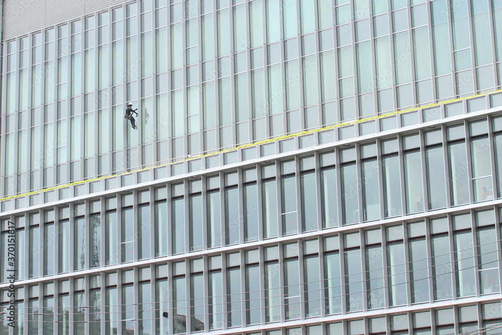 A man cleaning the windows of a building