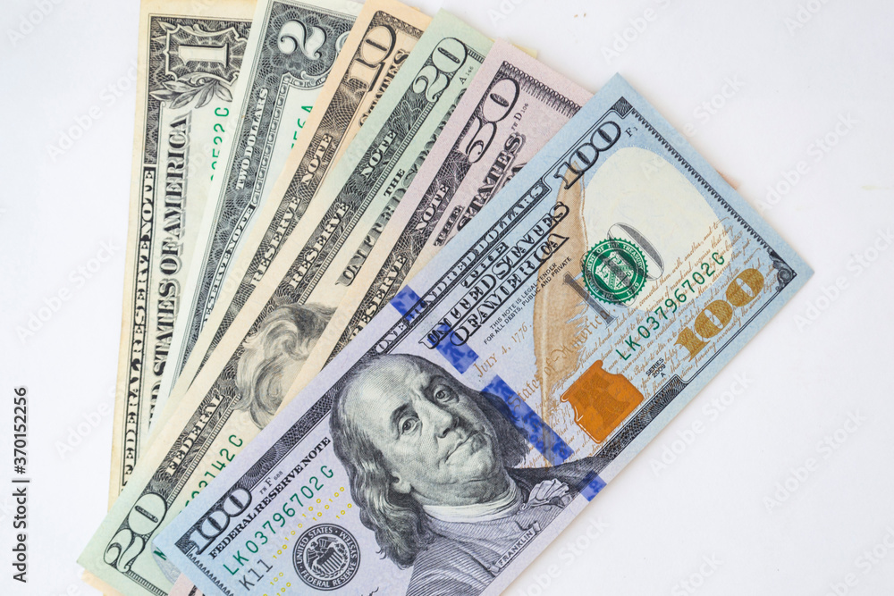 Stack of money American dollar bills on a white background. The concept of buying for dollars Stack of money American dollar bills on a white background. The concept of buying for dollars
