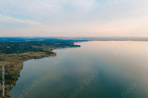 Aerial view of the picturesque landscape of land, trees, sky reflected in to the water. Go into the wild. Discover earth places. © arthurhidden