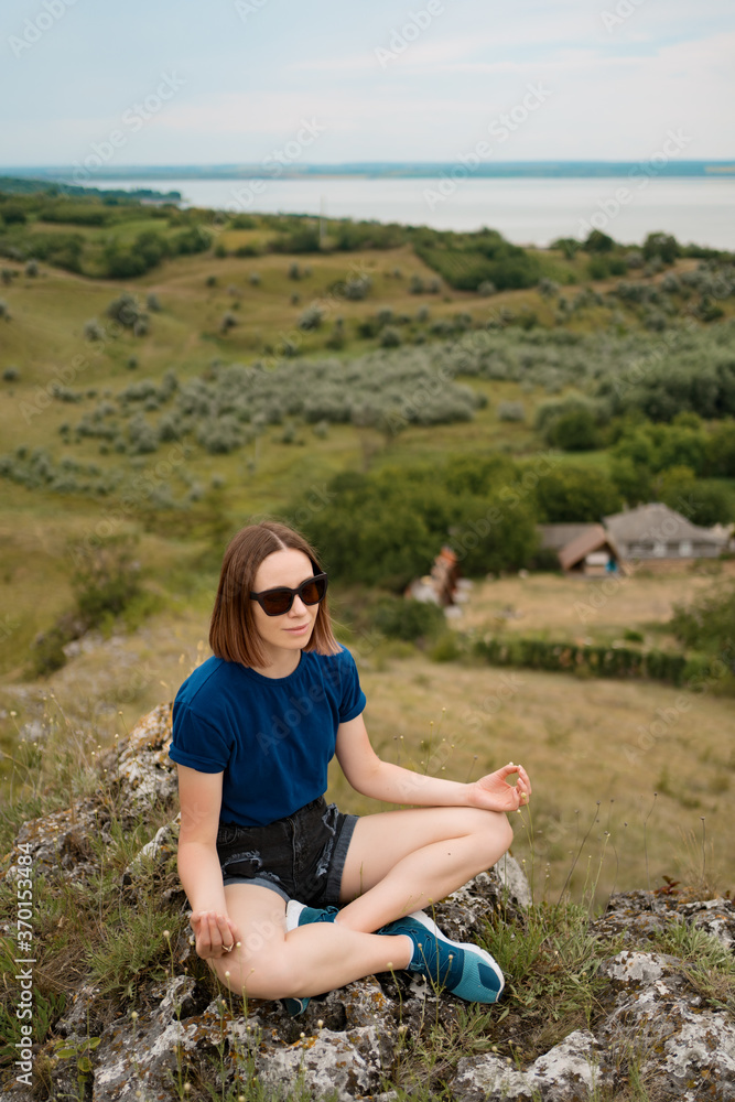 Woman meditating relaxing alone. Travel healthy Lifestyle with beautiful landscape on background outdoors Woman meditating relaxing alone. Travel healthy Lifestyle with beautiful landscape on background outdoors