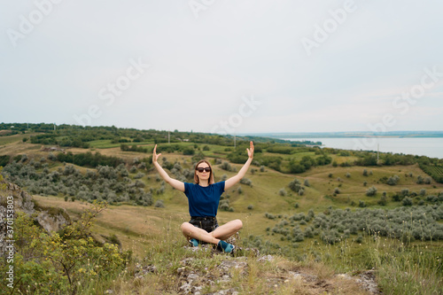 Woman meditating relaxing alone. Travel healthy Lifestyle with beautiful landscape on background outdoors