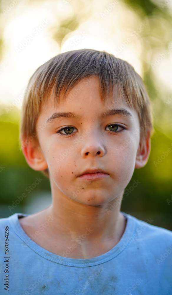 Portrait of little cute boy in blue shirt posing outdoors Portrait of little cute boy in blue shirt posing outdoors