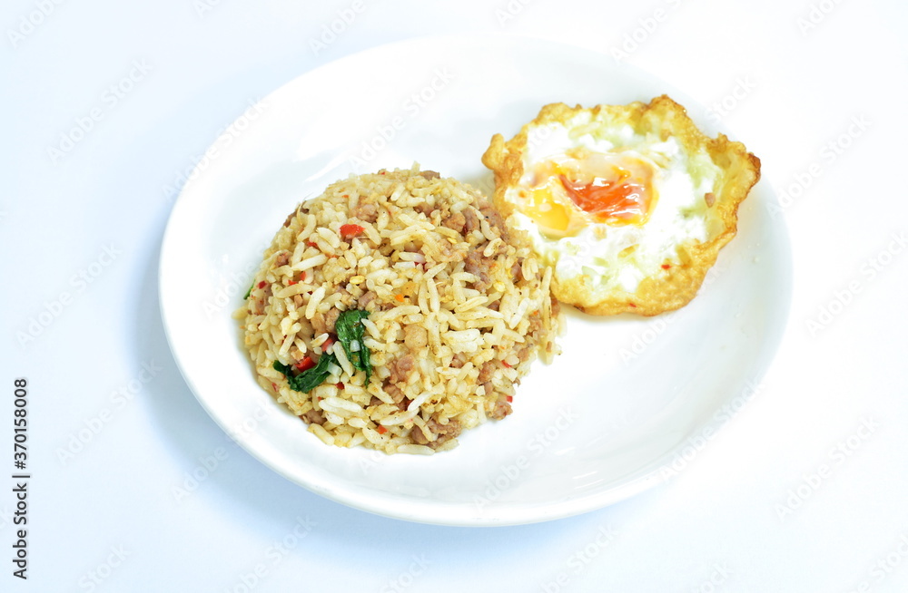 spicy stir fried chop pork with chili and basil leaf mixed rice topping egg on plate spicy stir fried chop pork with chili and basil leaf mixed rice topping egg on plate