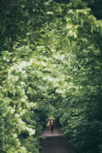 Young blonde woman walking in the forest photo