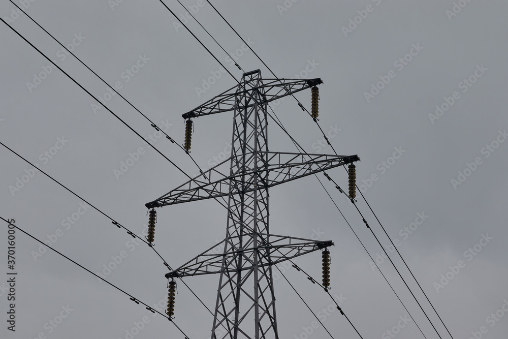 High voltage power lines conducting energy and power. Stock Photo