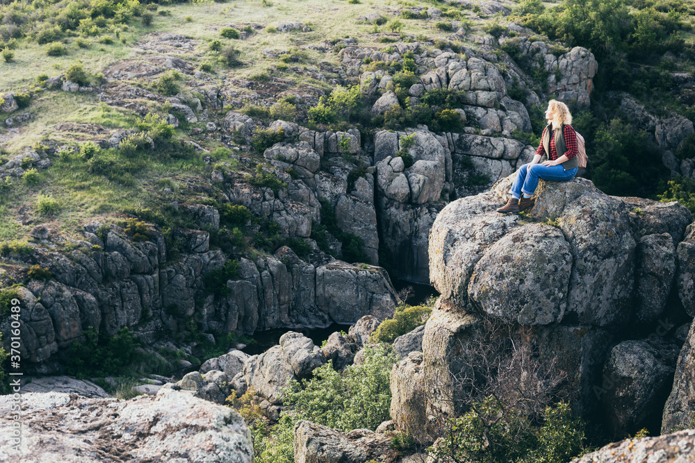 Woman with backpack hiking in the mountains Woman with backpack hiking in the mountains