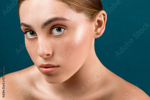 Beautiful young woman with clean perfect skin. Portrait of beauty model with natural nude make up and long eyelashes. 