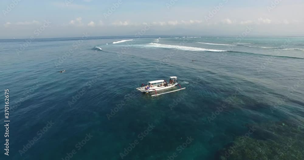 AERIAL static shot of boat near coral reef in Bali Indonesia AERIAL static shot of boat near coral reef in Bali Indonesia