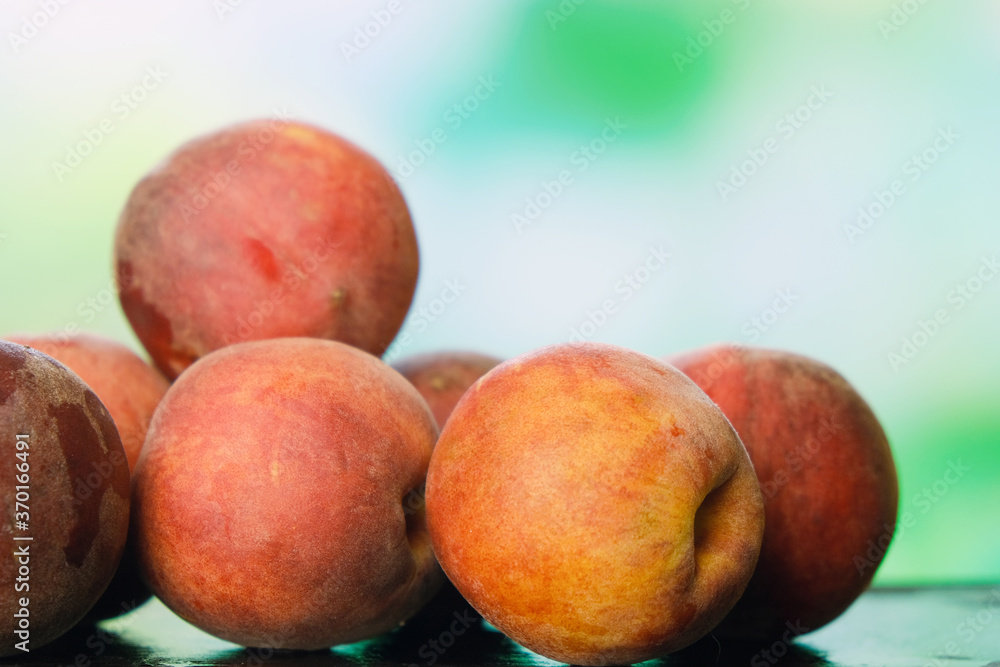 Heap of fresh peaches on natural green background. Summer harvest of peaches. Fruits background. Heap of fresh peaches on natural green background. Summer harvest of peaches. Fruits background.