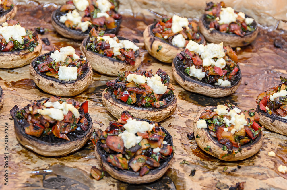 Cooked mushrooms stuffed with vegetables, cheese and meat