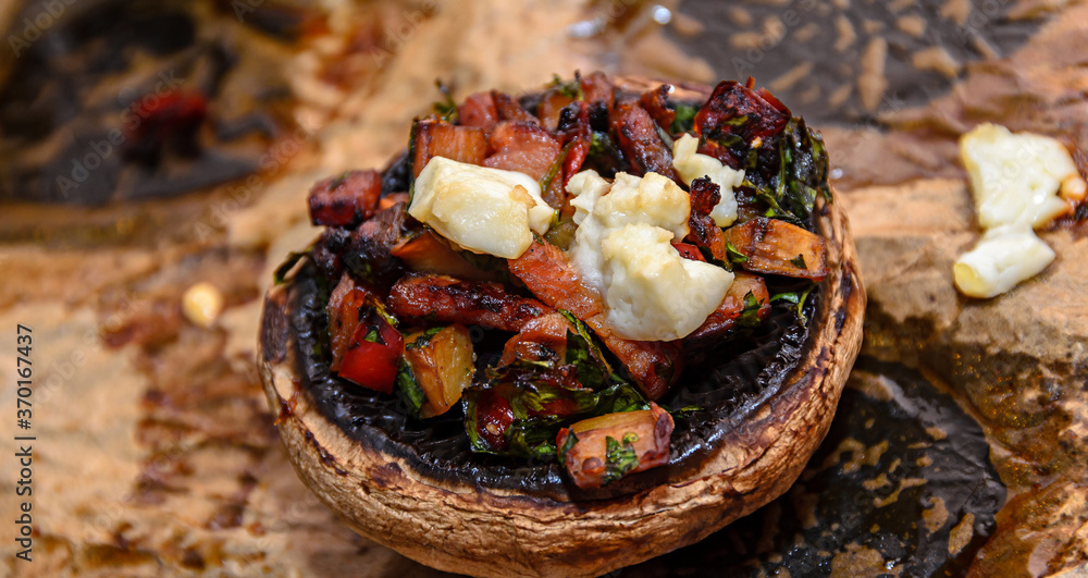 Fototapeta premium Cooked mushrooms stuffed with vegetables, cheese and meat