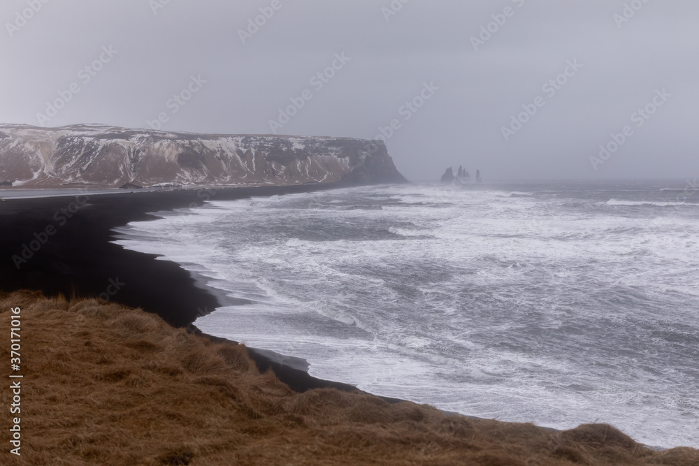 storm on Iceland's black beach and winter Atlantic Ocean