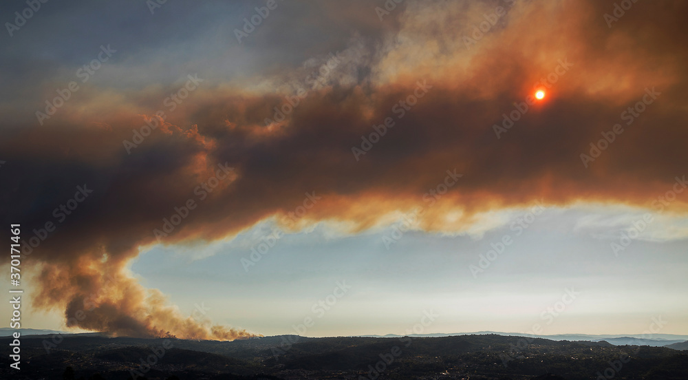 Toen, Ourense, Galicia, España; 08, 07, 2020: A spectacular forest fire in Toen, Ourense, burns 200 hectares and causes a cloud of smoke that eclipses the sun