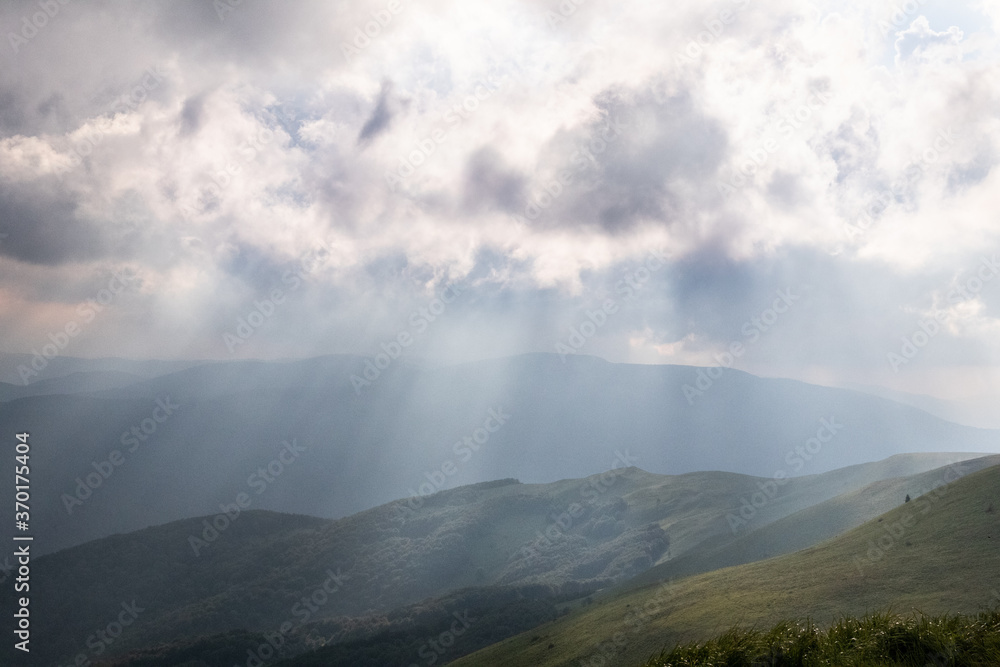 Sun rays illuminating slopes, Bieszczady Mountains, Poland